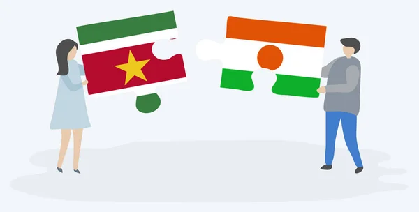 スリナムとナイジェリアの旗を持つ2つのパズルピースを保持しているカップル スリナムとニジェールのシンボル — ストックベクタ