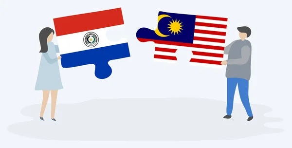 一对夫妇拿着两块拼图 上面挂着巴拉圭和马来西亚国旗 巴拉圭和马来西亚国家符号在一起 — 图库矢量图片