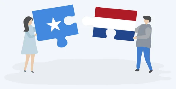 Dvojice Drží Dvě Skládanky Somali Holandskými Vlajkami Somálsko Nizozemské Národní — Stockový vektor
