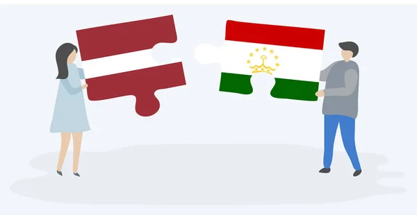 Pareja Sosteniendo Dos Piezas Rompecabezas Con Banderas Letonia Tayikistán Letonia — Archivo Imágenes Vectoriales