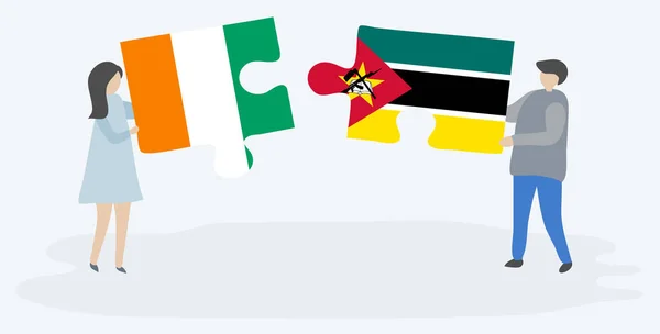 Çift Fildişi Mozambik Bayrakları Ile Iki Bulmaca Parçaları Tutan Fildişi — Stok Vektör
