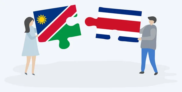 Pareja Sosteniendo Dos Piezas Rompecabezas Con Banderas Namibia Costa Rica — Vector de stock