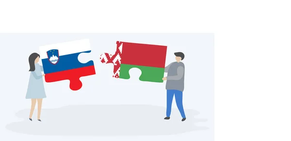 Para Trzymania Dwóch Puzzli Słoweńskimi Białoruskimi Flagami Słowenia Białoruś Symbole — Wektor stockowy