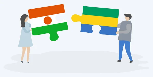 Pareja Sosteniendo Dos Piezas Rompecabezas Con Banderas Nigerianas Gabonesas Níger — Vector de stock
