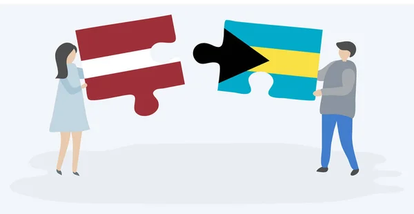 一对夫妇拿着两个拼图片与拉脱维亚和巴哈马国旗 拉脱维亚和巴哈马国家符号在一起 — 图库矢量图片