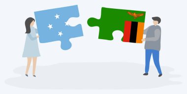 Mikronezya ve Zambiya bayrakları ile iki bulmaca parçaları tutan çift. Mikronezya ve Zambiya ulusal sembolleri birlikte.