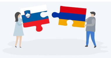 Sloven ve Ermeni bayraklarıyla iki bulmaca tutan çift. Slovenya ve Ermenistan ulusal sembolleri birlikte.