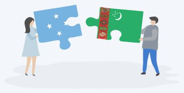 Mikronezya ve Türkmen bayrakları ile iki bulmaca parçaları tutan çift. Mikronezya ve Türkmenistan ulusal sembolleri birlikte.