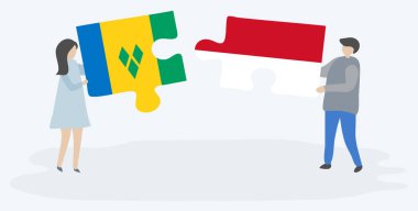 Vincentian ve Monegasque bayrakları ile iki bulmaca parçaları tutan çift. Saint Vincent ve Grenadinler ve Monako ulusal sembolleri birlikte.