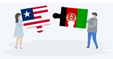 Liberya ve Afgan bayrakları ile iki bulmaca parçaları tutan çift. Liberya ve Afganistan ulusal sembolleri birlikte.