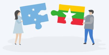 Mikronezya ve Birmanya bayrakları ile iki bulmaca parçaları tutan çift. Mikronezya ve Myanmar ulusal sembolleri birlikte.