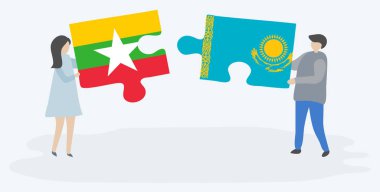 Birmanya ve Kazak bayrakları ile iki bulmaca parçaları tutan çift. Myanmar ve Kazakistan ulusal sembolleri bir arada.