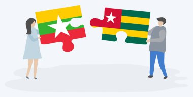 Birmanya ve Togolese bayrakları ile iki bulmaca parçaları tutan çift. Myanmar ve Togo ulusal sembolleri birlikte.