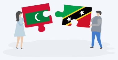 Çift Maldivian ve Kittitian bayrakları ile iki bulmaca parçaları tutan. Maldivler ve Saint Kitts ve Nevis ulusal semboller birlikte.