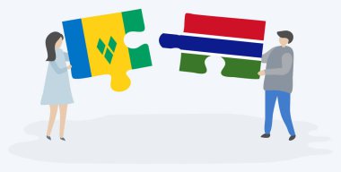 Vincentian ve Gambiya bayrakları ile iki bulmaca parçaları tutan çift. Saint Vincent ve Grenadinler ve Gambiya ulusal sembolleri birlikte.