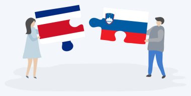 Çift Kosta Rika ve Sloven bayrakları ile iki bulmaca parçaları tutan. Kosta Rika ve Slovenya ulusal sembolleri birlikte.