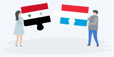 Suriye ve Lüksemburg bayrakları ile iki bulmaca parçaları tutan çift. Suriye ve Lüksemburg ulusal sembolleri birlikte.