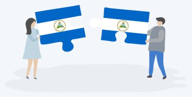 Nikaragua ve Nikaragua bayrakları ile iki bulmaca parçaları tutan çift. Nikaragua ve Nikaragua ulusal sembolleri birlikte.