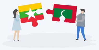 Çift Birmanya ve Maldiv bayrakları ile iki bulmaca parçaları tutan. Myanmar ve Maldivler ulusal semboller birlikte.
