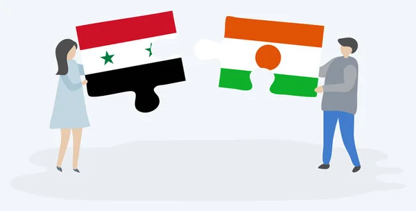 シリアとナイジェリアの旗を持つ2つのパズルピースを保持しているカップル シリアとニジェールのシンボル — ストックベクタ