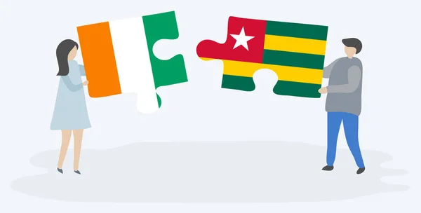 Casal Segurando Duas Peças Quebra Cabeças Com Bandeiras Marfinenses Togolesas — Vetor de Stock