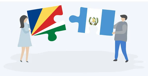 Casal Segurando Duas Peças Quebra Cabeças Com Seychellois Bandeiras Guatemaltecas — Vetor de Stock