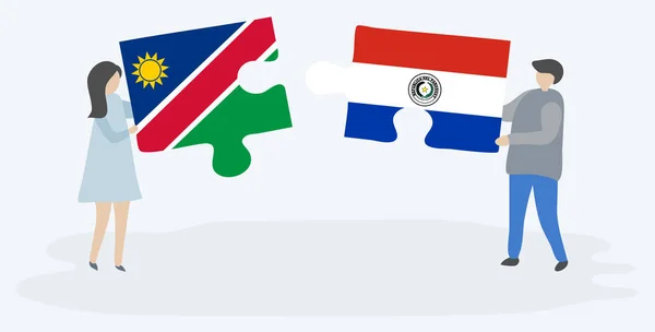 一对夫妇拿着两块拼图 上面挂着纳米比亚和巴拉圭国旗 纳米比亚和巴拉圭国家符号在一起 — 图库矢量图片