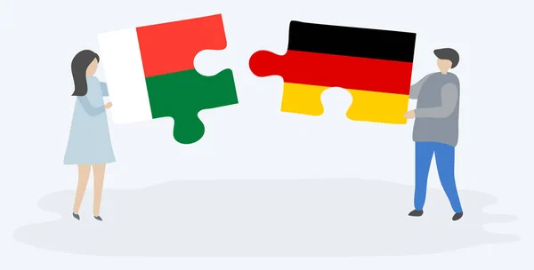 Couple Holding Two Puzzles Pieces Malagasy German Flags Madagascar Germany — Stock Vector