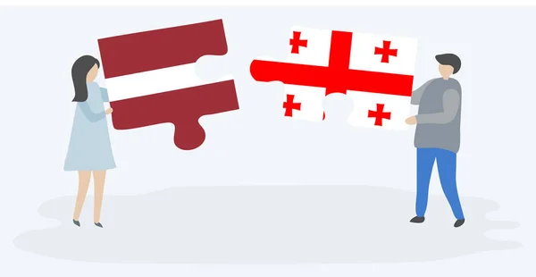 Dvojice Která Drží Dvě Skládanky Lotyšskými Gruzínskými Vlajkami Národní Symboly — Stockový vektor