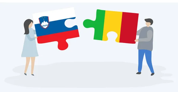 一对夫妇拿着两个拼图 上面挂着斯洛文尼亚和马里国旗 斯洛文尼亚和马里国家符号在一起 — 图库矢量图片