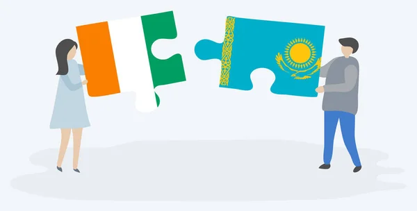 Par Som Innehar Två Pusselbitar Med Ivorianska Och Kazakiska Flaggor — Stock vektor