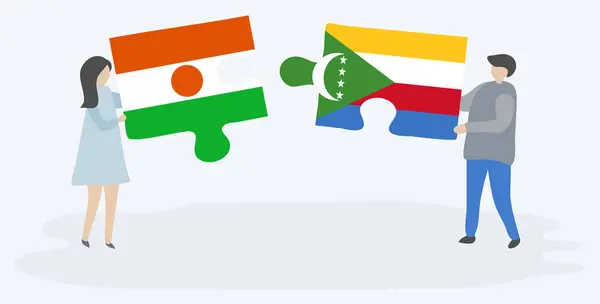 Пара Держащая Две Головоломки Нигерийскими Коморскими Флагами Государственные Символы Нигера — стоковый вектор