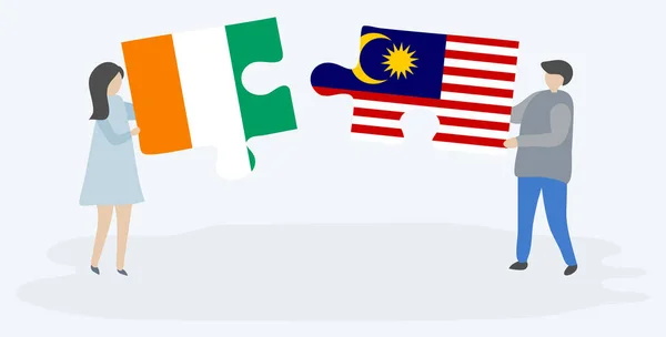 Пара Держащая Две Головоломки Ивуарским Малайзийским Флагами Кот Ивуар Малайзия — стоковый вектор
