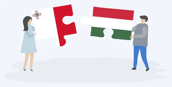 マルタとハンガリーの旗を持つ2つのパズルのピースを保持しているカップル マルタとハンガリーのシンボル — ストックベクタ