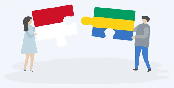 モネガスクとガボンの旗を持つ2つのパズルピースを保持しているカップル モナコとガボンの国のシンボルが一緒に — ストックベクタ