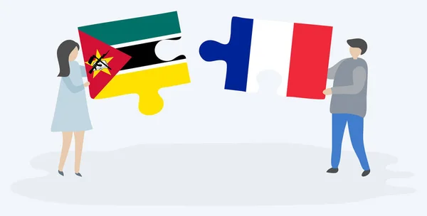モザンビークとフランスの旗で2つのパズルのピースを保持しているカップル モザンビークとフランスの国のシンボル — ストックベクタ