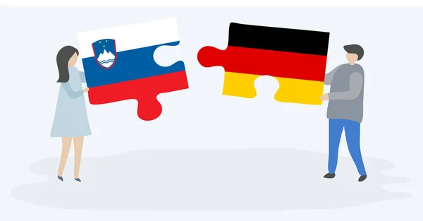 一对夫妇拿着两个拼图 上面挂着斯洛文尼亚和德国国旗 斯洛文尼亚和德国的国家符号在一起 — 图库矢量图片