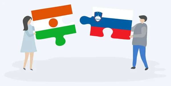 Ζευγάρι Που Κρατά Δύο Κομμάτια Παζλ Σημαίες Νιγηριέν Και Σλοβένικες — Διανυσματικό Αρχείο