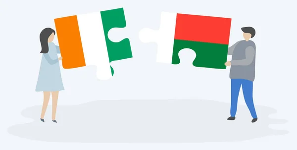 Çift Fildişi Malagasy Bayrakları Ile Iki Bulmaca Parçaları Tutan Fildişi — Stok Vektör