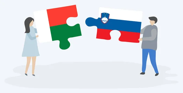 Pareja Sosteniendo Dos Piezas Rompecabezas Con Banderas Malgaches Eslovenas Madagascar — Vector de stock