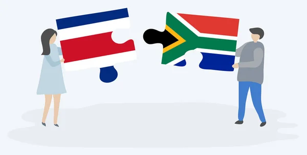 Pareja Sosteniendo Dos Piezas Rompecabezas Con Banderas Costa Rica Sudáfrica — Vector de stock