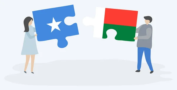 Par Som Innehar Två Pusselbitar Med Somaliska Och Malagassiska Flaggor — Stock vektor