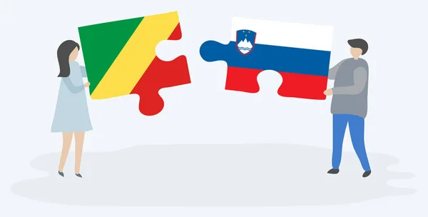 一对夫妇拿着两块拼图 上面挂着刚果和斯洛文尼亚国旗 刚果共和国和斯洛文尼亚国家象征在一起 — 图库矢量图片