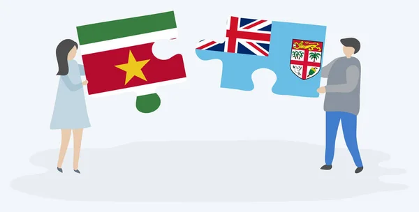 Pareja Sosteniendo Dos Piezas Rompecabezas Con Banderas Suriname Fiji Surinam — Vector de stock