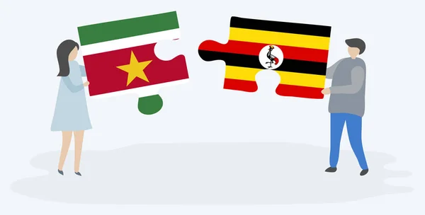 Para Trzymania Dwóch Puzzli Surinamu Ugandy Flagi Surinam Uganda Symbole — Wektor stockowy