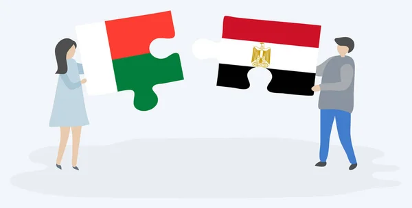 Par Som Innehar Två Pusselbitar Med Madagassiska Och Egyptiska Flaggor — Stock vektor