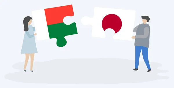 Пара Держащая Две Головоломки Малагасийскими Японскими Флагами Мадагаскар Япония Вместе — стоковый вектор