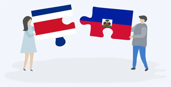 Pareja Sosteniendo Dos Piezas Rompecabezas Con Banderas Costa Rica Haití — Vector de stock