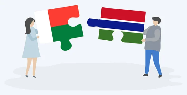 Пара Держащая Две Головоломки Малагасийским Гамбийским Флагами Мадагаскар Гамбия Вместе — стоковый вектор