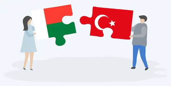 Casal Segurando Duas Peças Quebra Cabeças Com Bandeiras Malgaxes Turcas — Vetor de Stock
